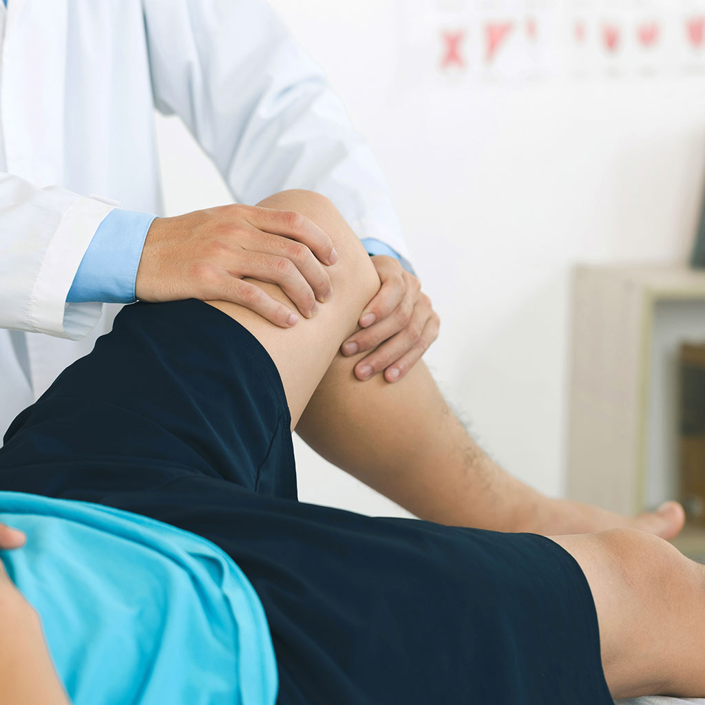 Picture of doctor examining a man's left knee